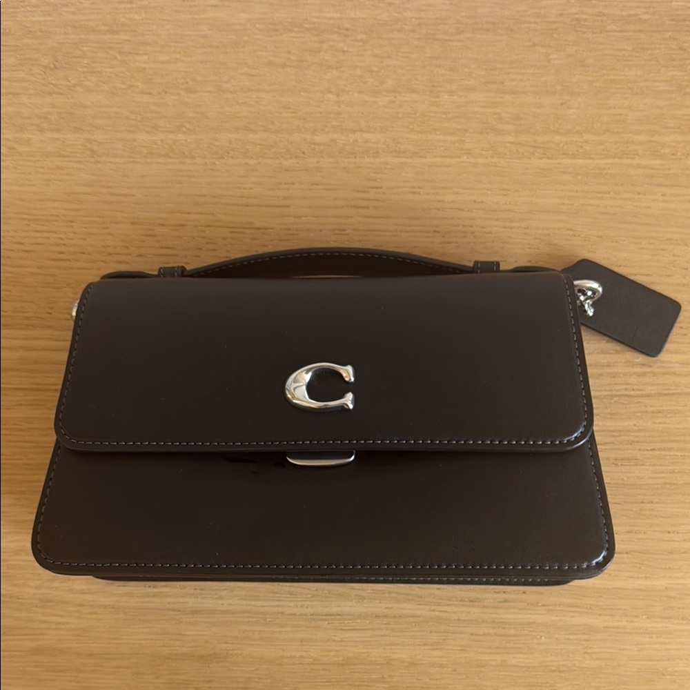 Coach Juno Black Leather Handbag with Silver Accents

One of one